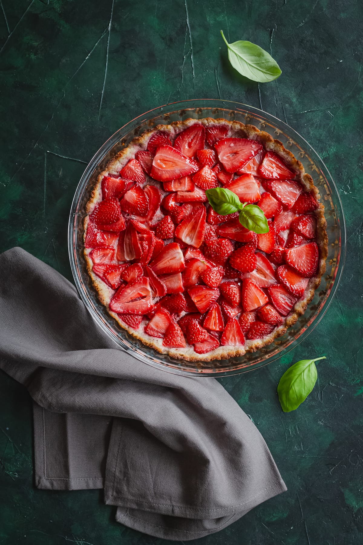 strawberry pie on a green background, flat lay