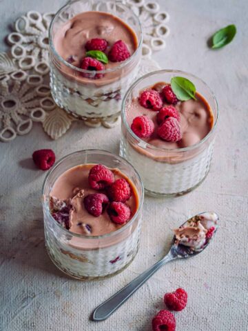 three glasses with raspberry dessert