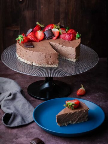 chocolate cake with strawberry decoration and a slice aside