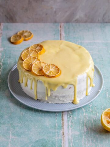 a cake with white chocolate glaze and lemon slices