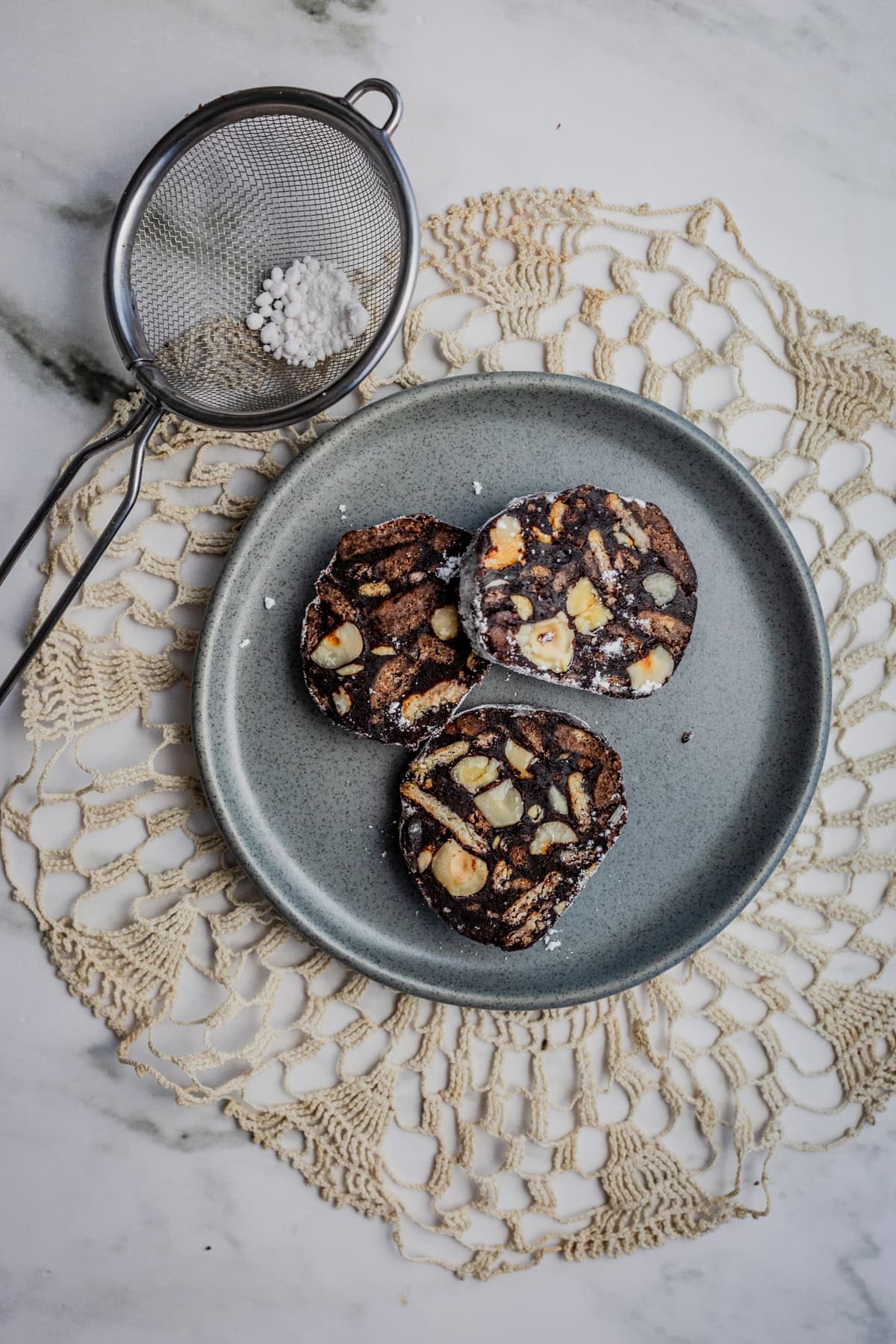 3 slices of chocolate salami on a plate