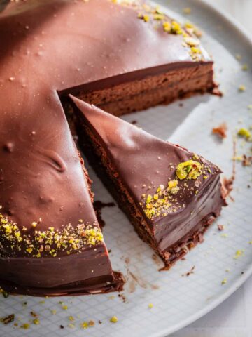 sliced chocolate cake with pistachio decoration