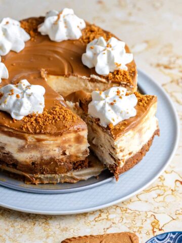 Biscoff Cheesecake on a plate with one slice slightly out